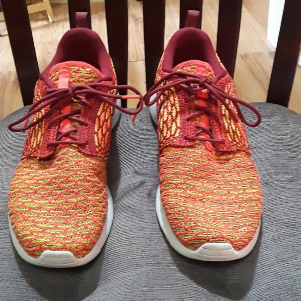 Burgundy and gold Nike Roshes